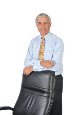 Businessman Leaning on Back of His Chair