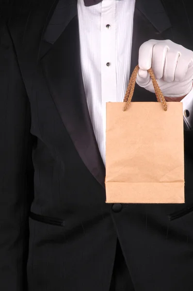 Hombre en esmoquin con bolsa marrón — Foto de Stock