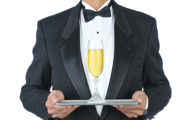 Человек в смокинге шампанское на подносе — стоковое фото