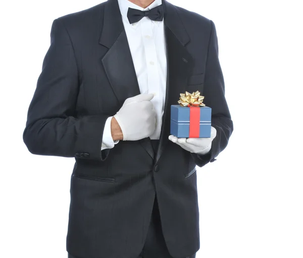 Mand i Tuxedo med gave - Stock-foto