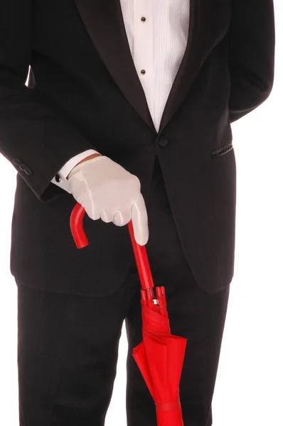 Человек в смокинге с красным зонтиком — стоковое фото