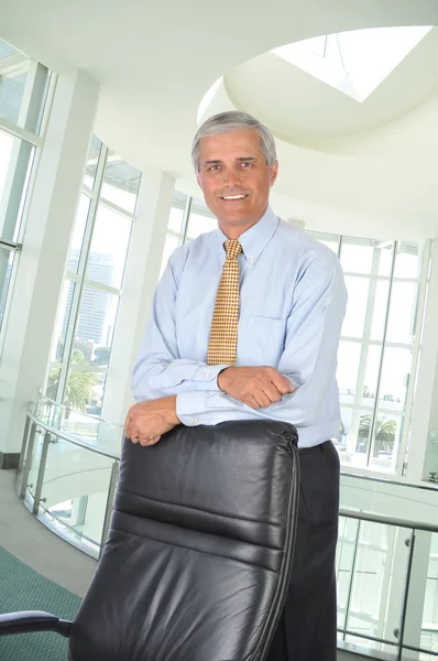 Businessman Leaning on Chair — Stock Photo, Image