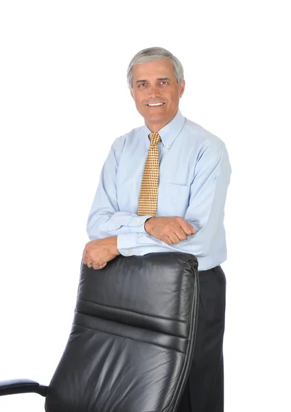 Businessman Leaning on Back of His Chair Royalty Free Stock Images