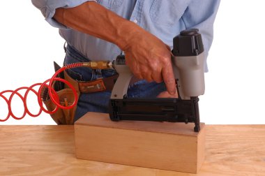 Carpenter using nail gun clipart