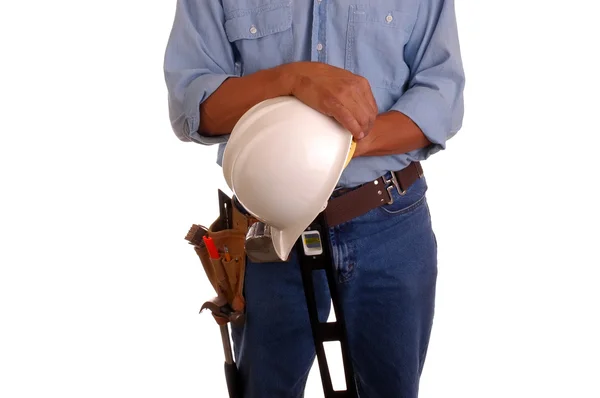 Carpenter holding level & hardhat — Stock Photo, Image