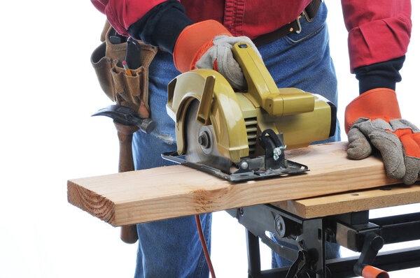 Construction Worker Cutting Beam with circular saw isolated over white