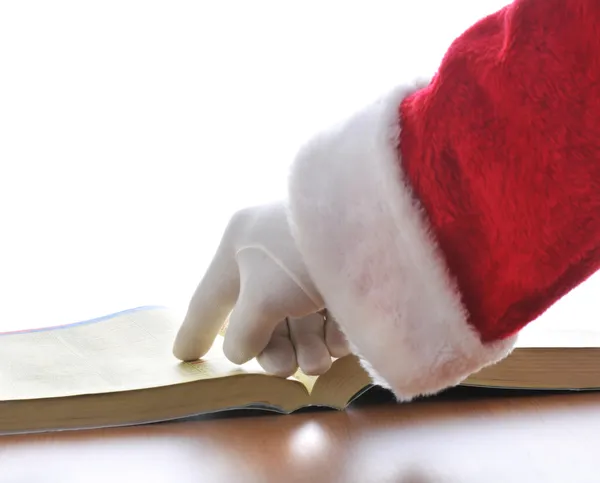Santa, wskazując na książki telefonicznej — Zdjęcie stockowe