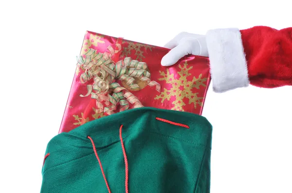 Weihnachtsmann nimmt Geschenk aus der Tasche — Stockfoto