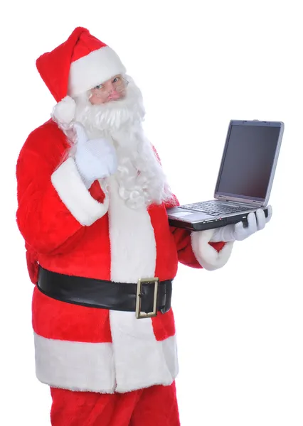 Santa Claus Holding Laptop tommelfingre op - Stock-foto
