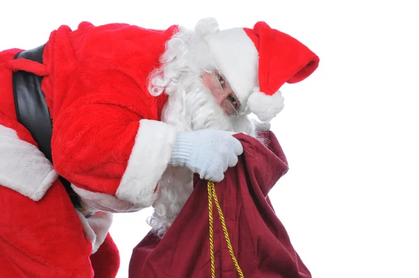 Santa op zoek in zijn zak — Stockfoto