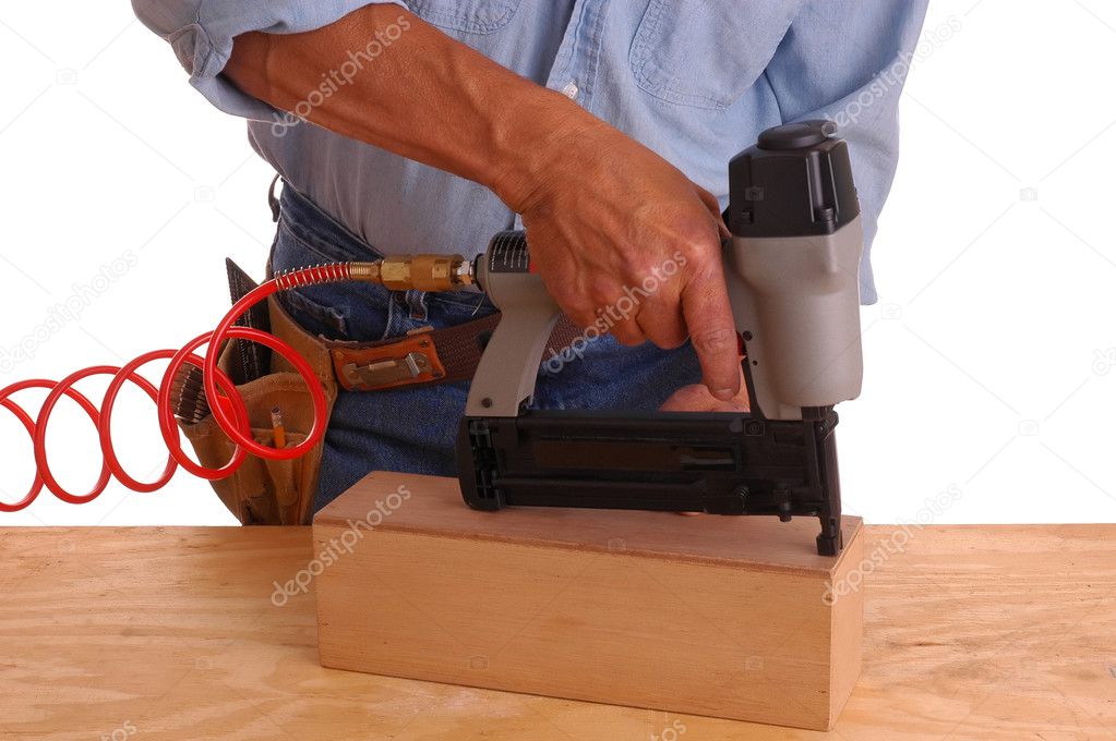 Carpenter using nail gun