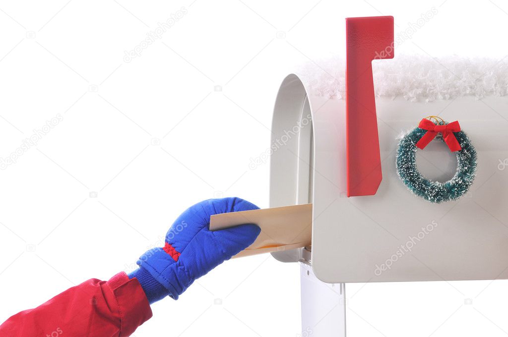 Childs hand placing letter in Mailbox