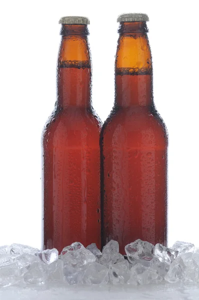Iki kahverengi bira şişe buz içinde — Stok fotoğraf