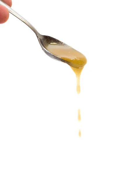 Honey drip from spoon — Stock Photo, Image
