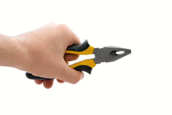 Manlig hand med svarta och gula tång — Stockfoto