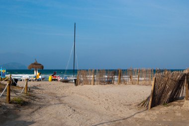 Beach and catamaran in Can Picafort clipart