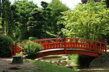 Red bridge in a japanese garden clipart