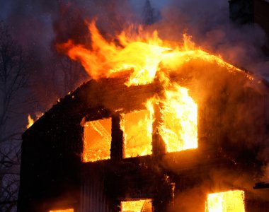 Wooden house in flames clipart