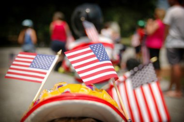 3 American flags in a parade clipart