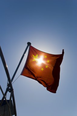 China National flag under dark blue sky clipart