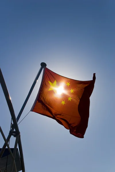 China National flag under dark blue sky — Stock Photo, Image