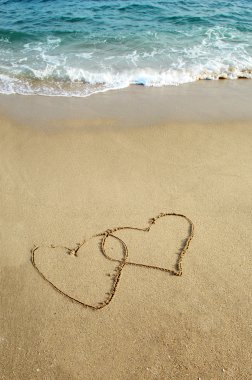 Two hearts drawn in beach clipart