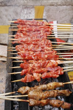 Closeup of shish kebab that is being gri clipart
