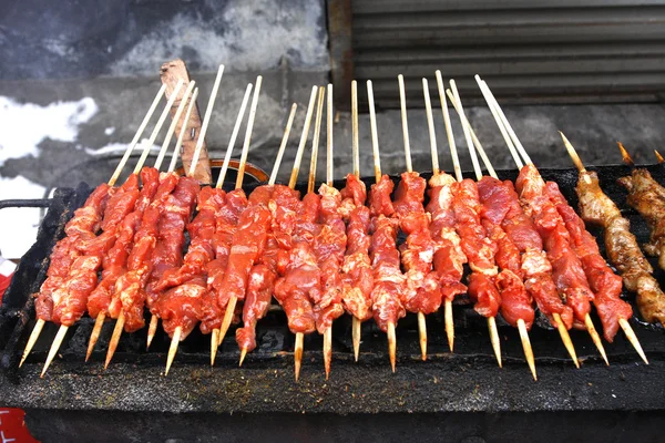 stock image Closeup of shish kebab that is being gri