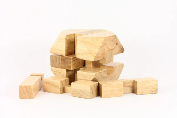 Quebra-cabeça de madeira em um fundo branco — Fotografia de Stock