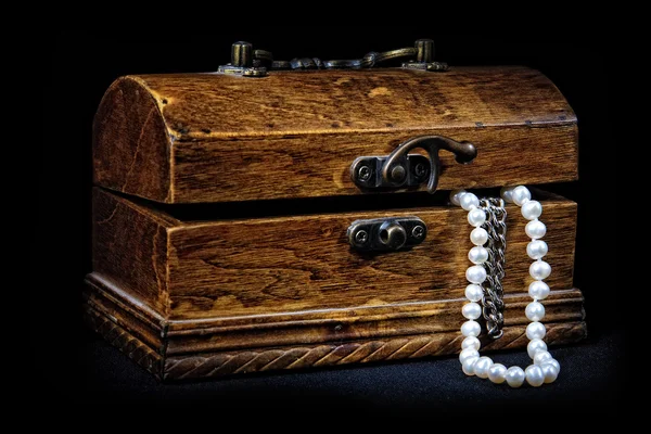 stock image Chest with treasures isolated on black