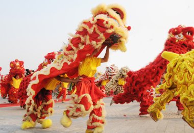 Chinese people playing lion dance celebrating the coming new year. clipart