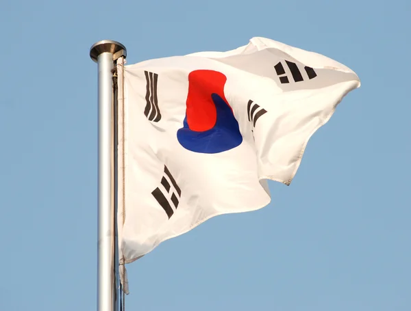 stock image Flag of South Korea waving in the wind against blue sky.