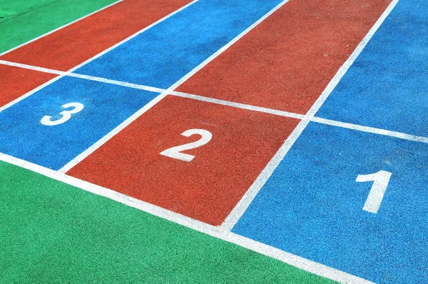 Stock image The colorful courses with white numbers on the playground.