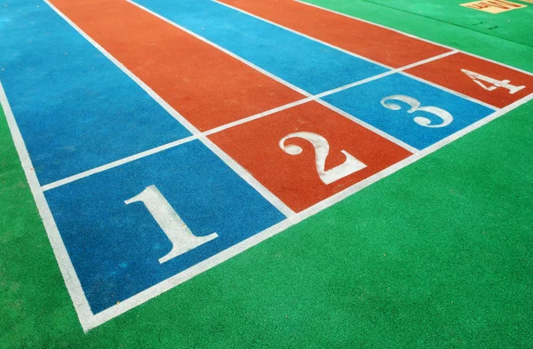 The colorful courses with white numbers on the playground. — Stock Photo, Image