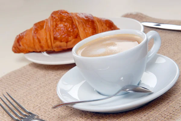 Stock image Cup of coffee with croissant