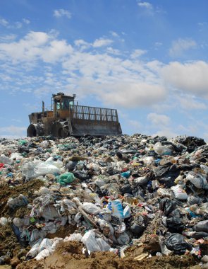 The bulldozer on a garbage dump clipart