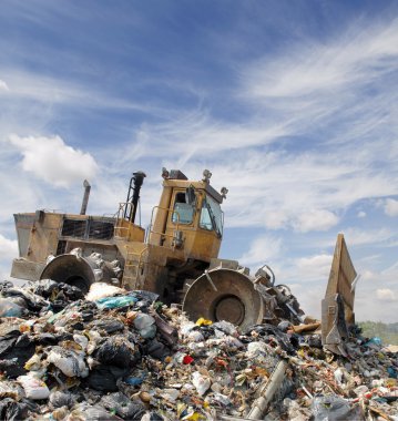 The bulldozer on a garbage dump clipart