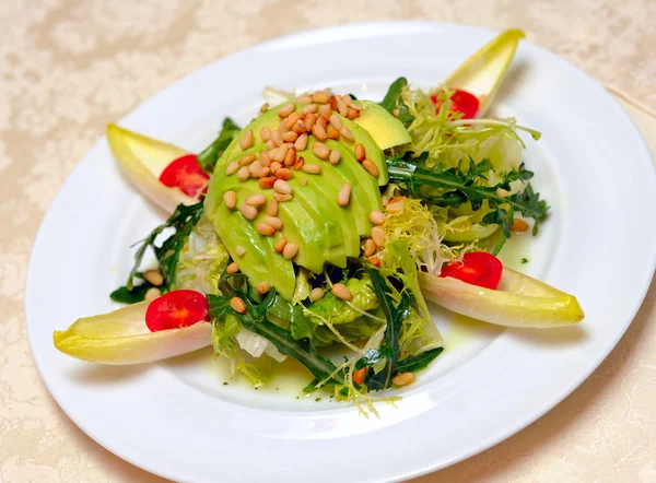Salad from avocado, pine nuts — Stock Photo, Image