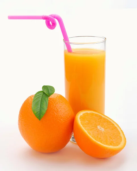 Χυμό πορτοκαλιού σε ένα ποτήρι και ένα πορτοκάλι — Φωτογραφία Αρχείου