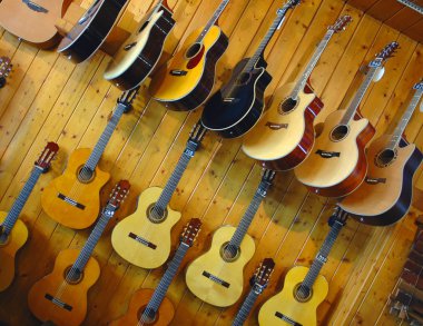 Guitars in shop of musical instruments clipart