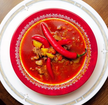 Soup a goulash from vegetables and veal clipart