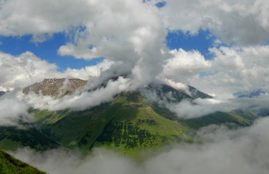 Panorama of Baksansky gorge in clouds clipart