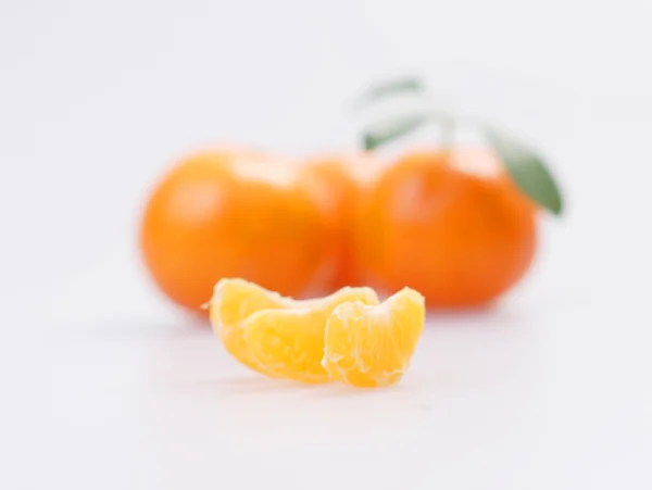 Three clementines with segments — Stock Photo, Image