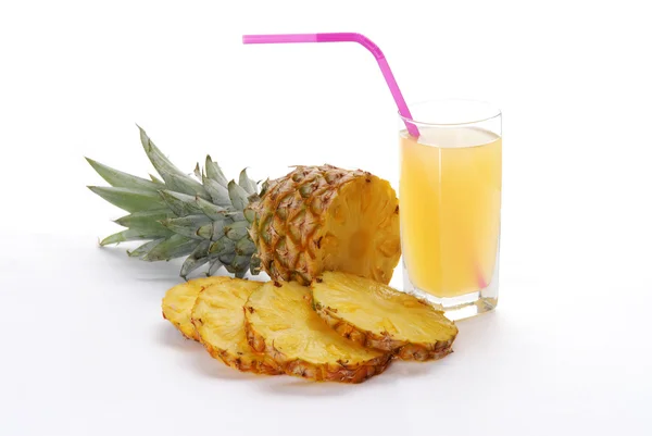 Pineapple with slices and juice — Stock Photo, Image