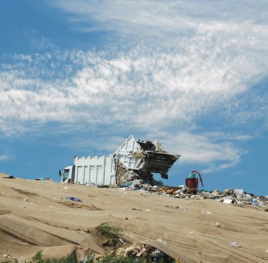 The garbage truck unloads dust clipart