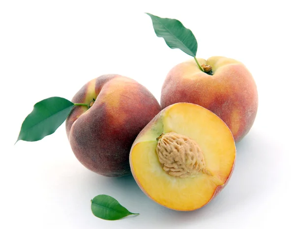 Peaches and a half and leaves — Stock Photo, Image
