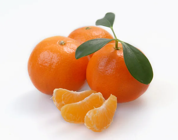 Three clementines with segments — Stock Photo, Image