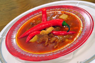 Soup a goulash from vegetables and veal clipart