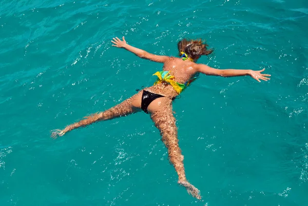 stock image The girl lies on water in Caribbean sea