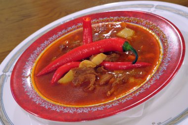 Soup a goulash from vegetables and veal clipart